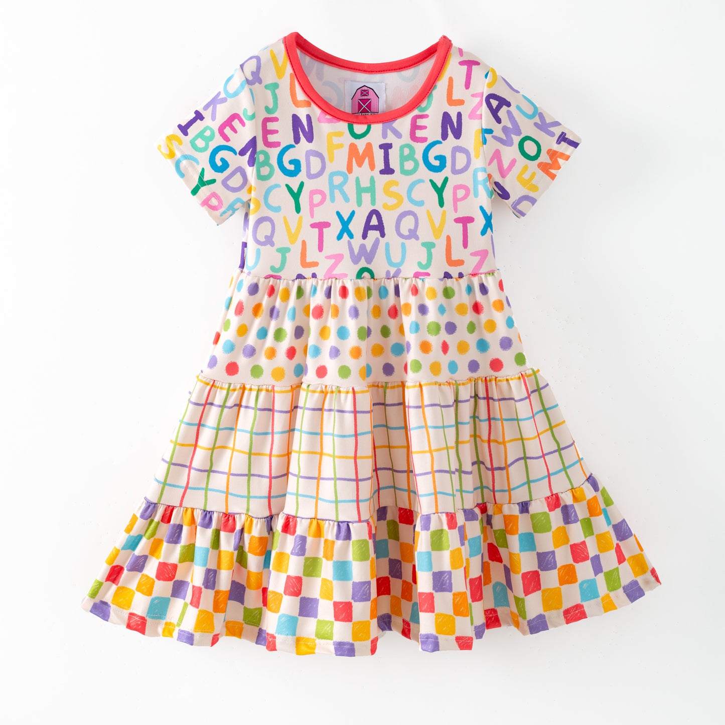 Colorful children's dress with alphabet pattern on a white background