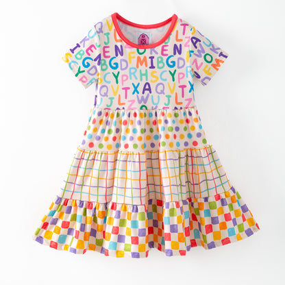 Colorful children's dress with alphabet pattern on a white background