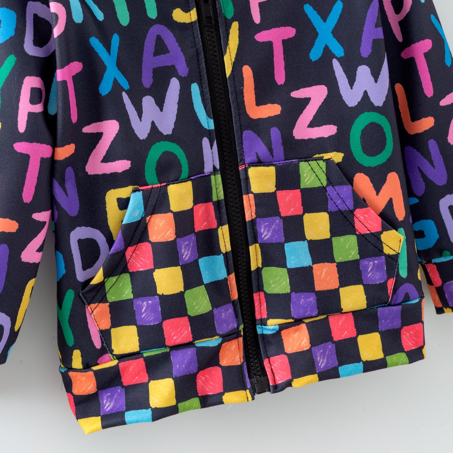 Colorful zipper hoodie with alphabet pattern on a plain background