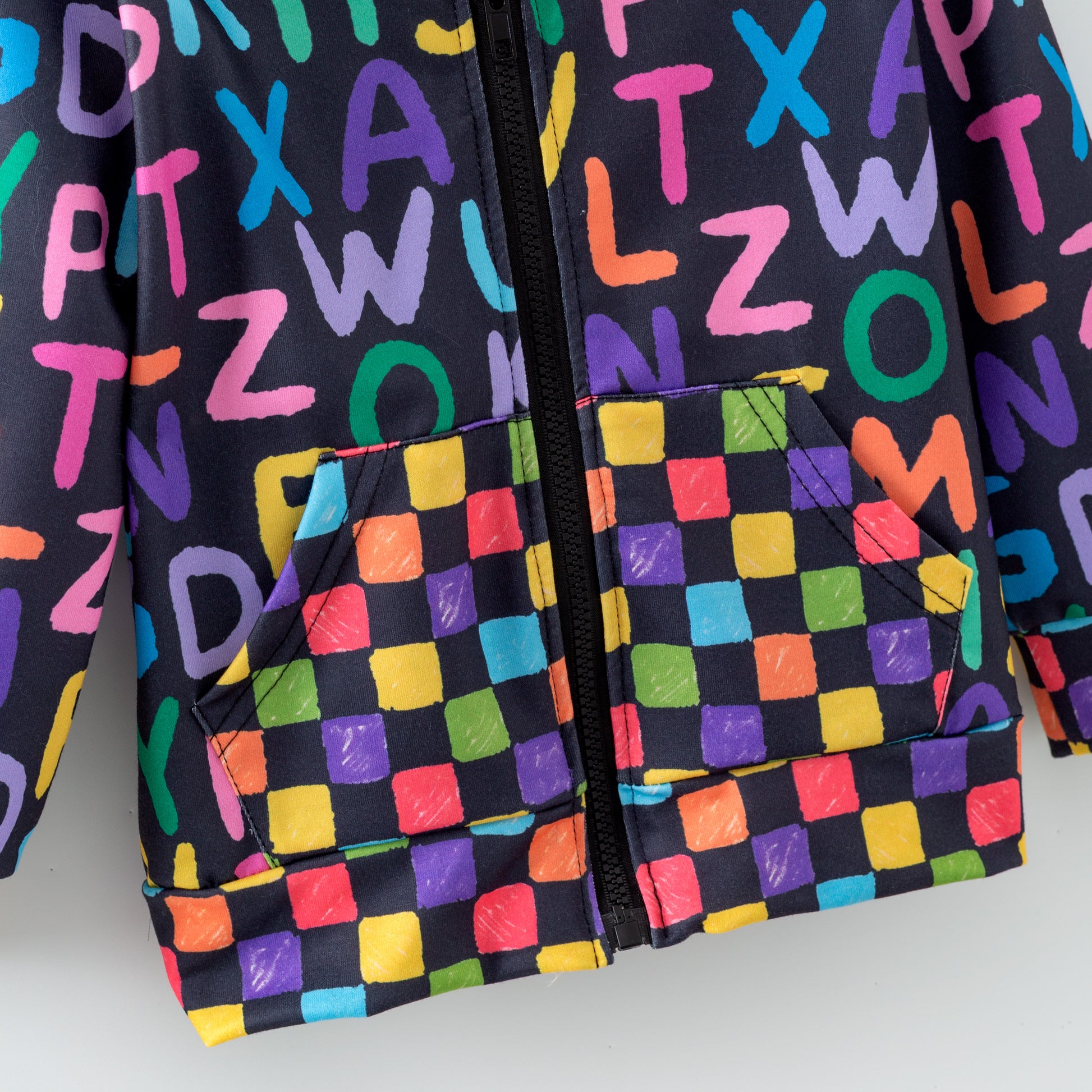 Colorful zipper hoodie with alphabet pattern on a plain background