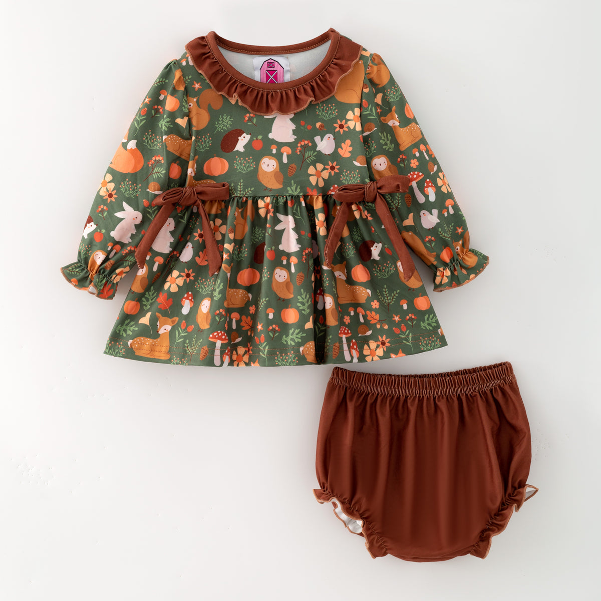 Children's outfit with a patterned top and brown bloomers on a white background