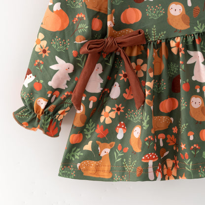 Children's dress with nature-themed print on a white background
