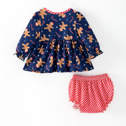 Children's Christmas-themed outfit with gingerbread pattern and candy cane details on a blue background