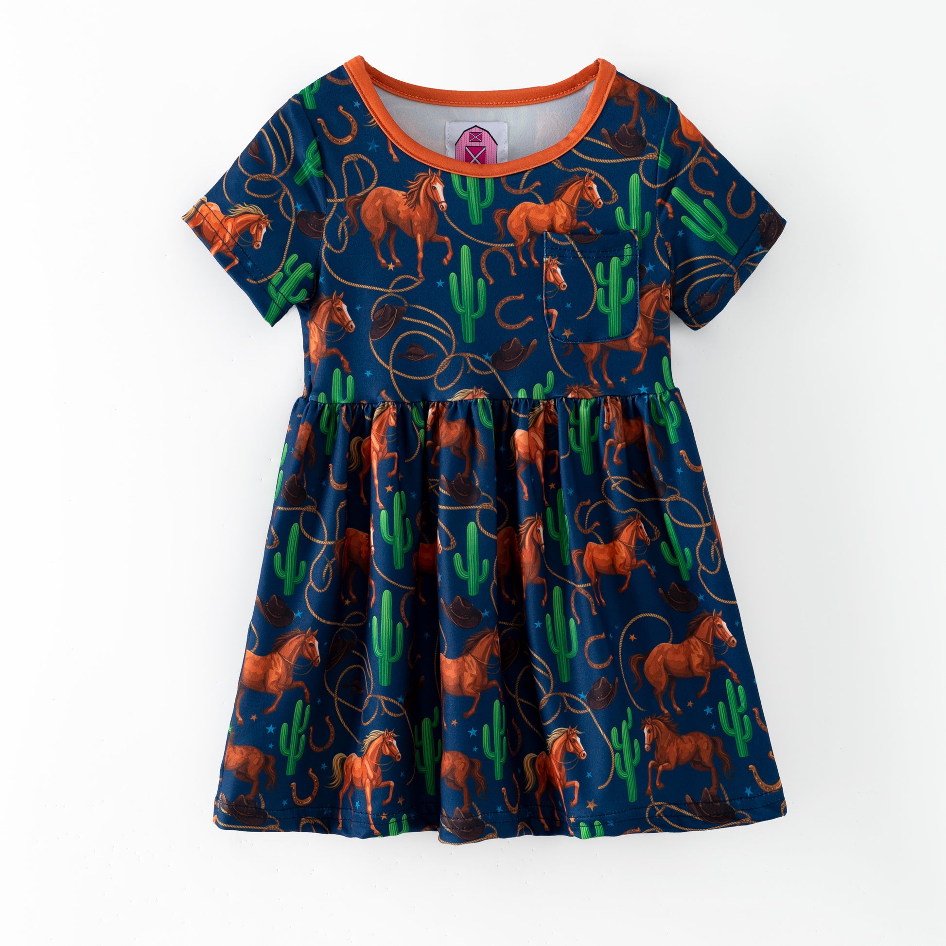 Children's dress with horse and cactus pattern on a blue background