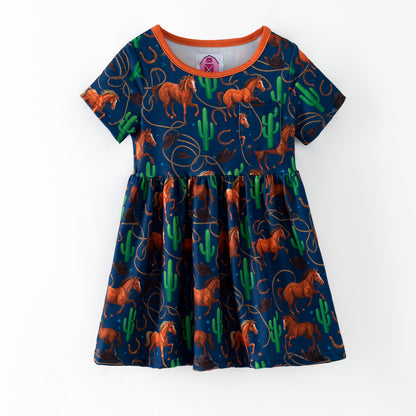 Children's dress with horse and cactus pattern on a blue background