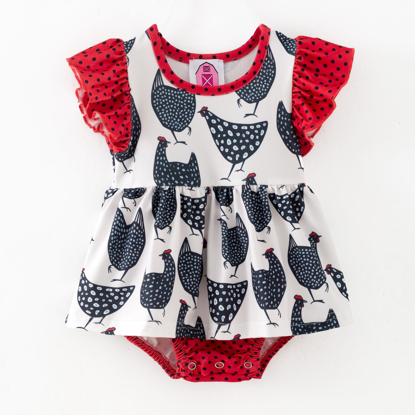 Children's romper with chicken pattern and red ruffled sleeves on a white background