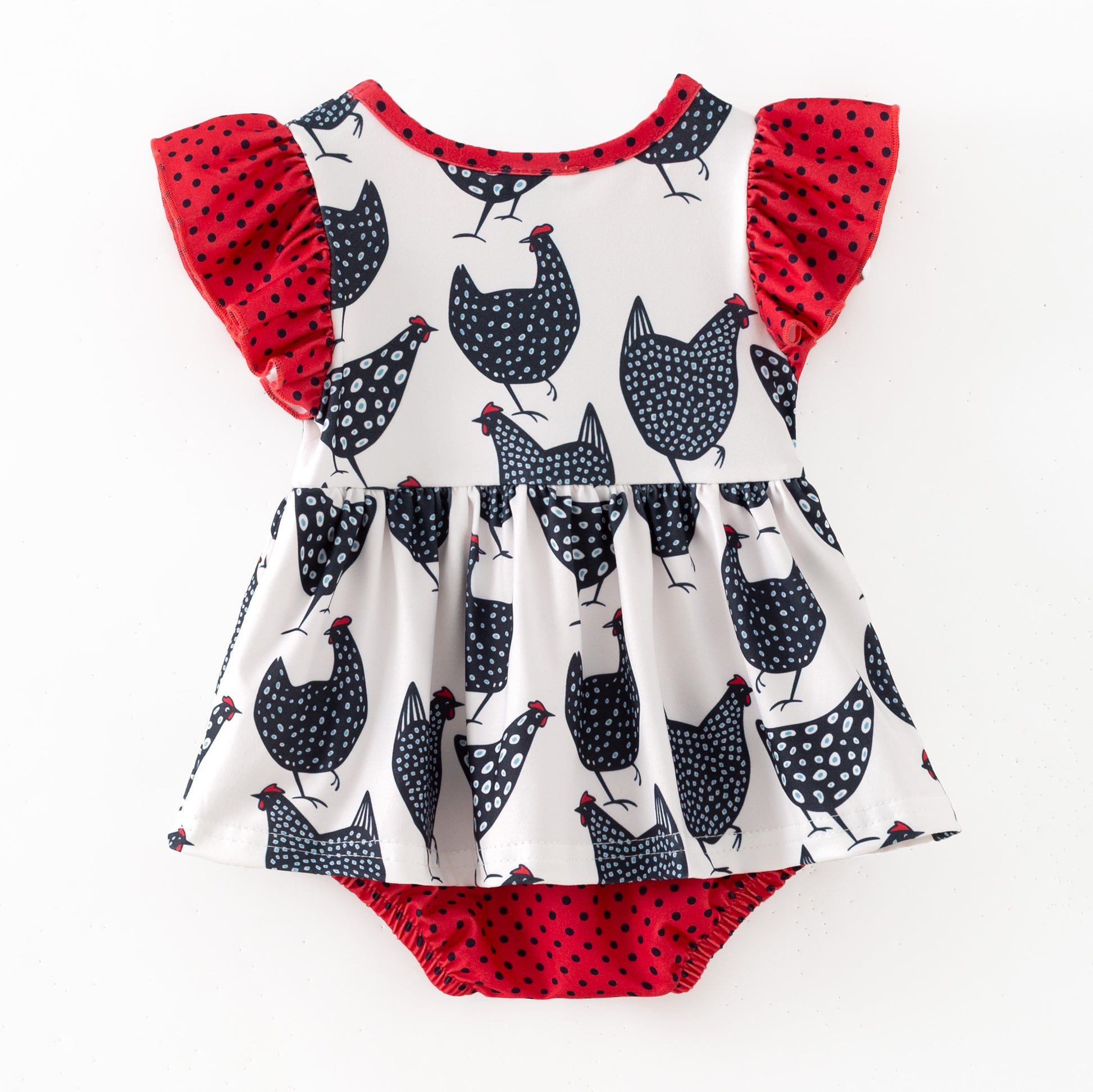 Children's romper with chicken pattern and red ruffled sleeves on a white background