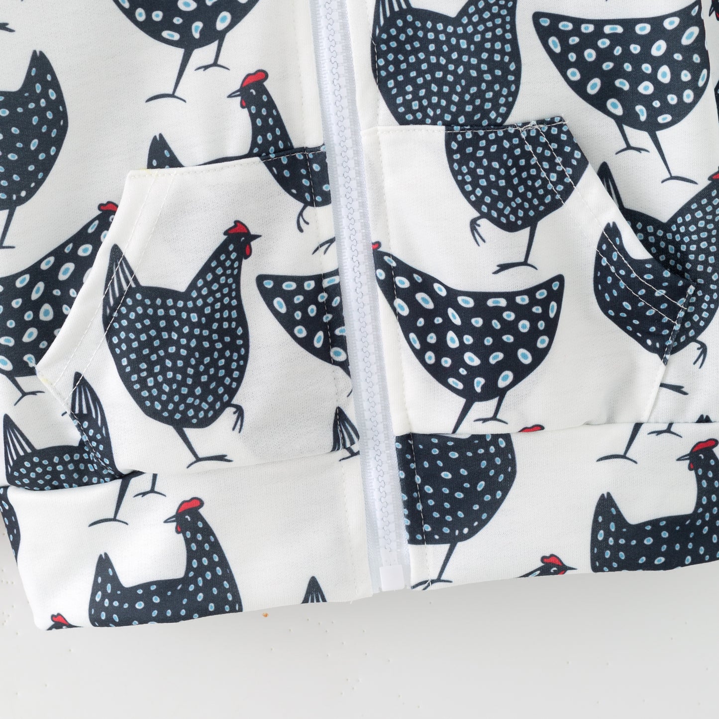 Fabric with black and white chicken pattern on a white background