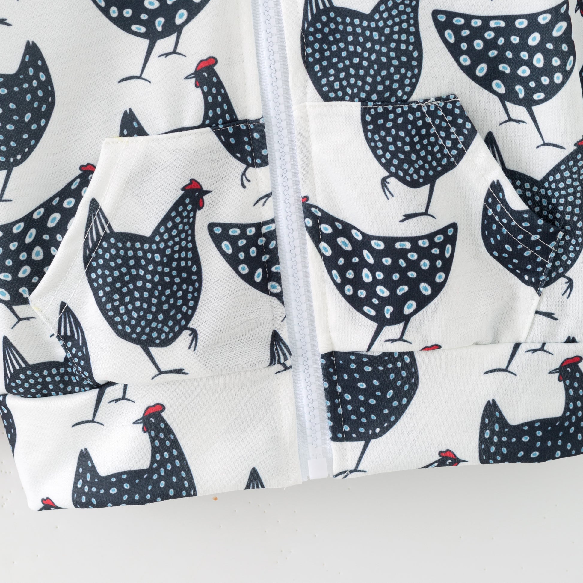 Fabric with black and white chicken pattern on a white background