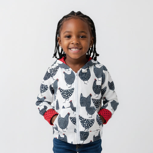 Child wearing a hoodie with chicken pattern on a white background