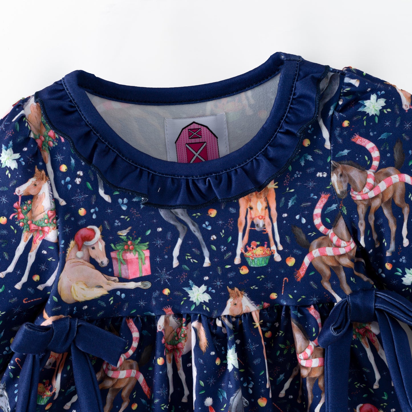 Navy blue children's outfit with printed Christmas horses on top and coordinating blue  bloomers. 