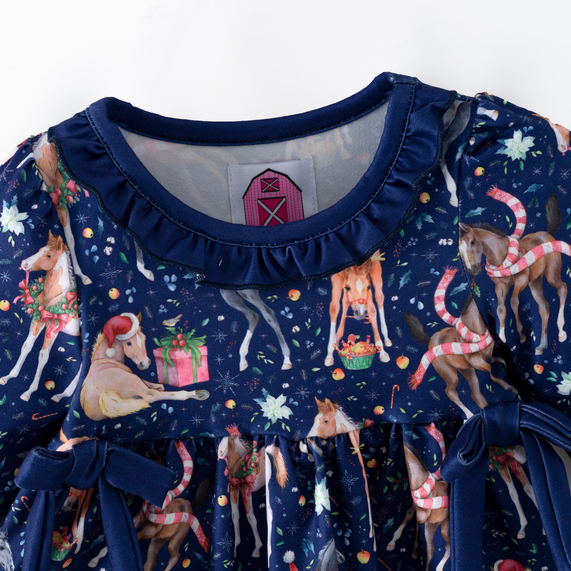 Navy blue children's outfit with printed Christmas horses on top and coordinating blue  bloomers. 
