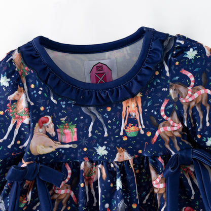 Navy blue children's outfit with printed Christmas horses on top and coordinating blue  bloomers. 