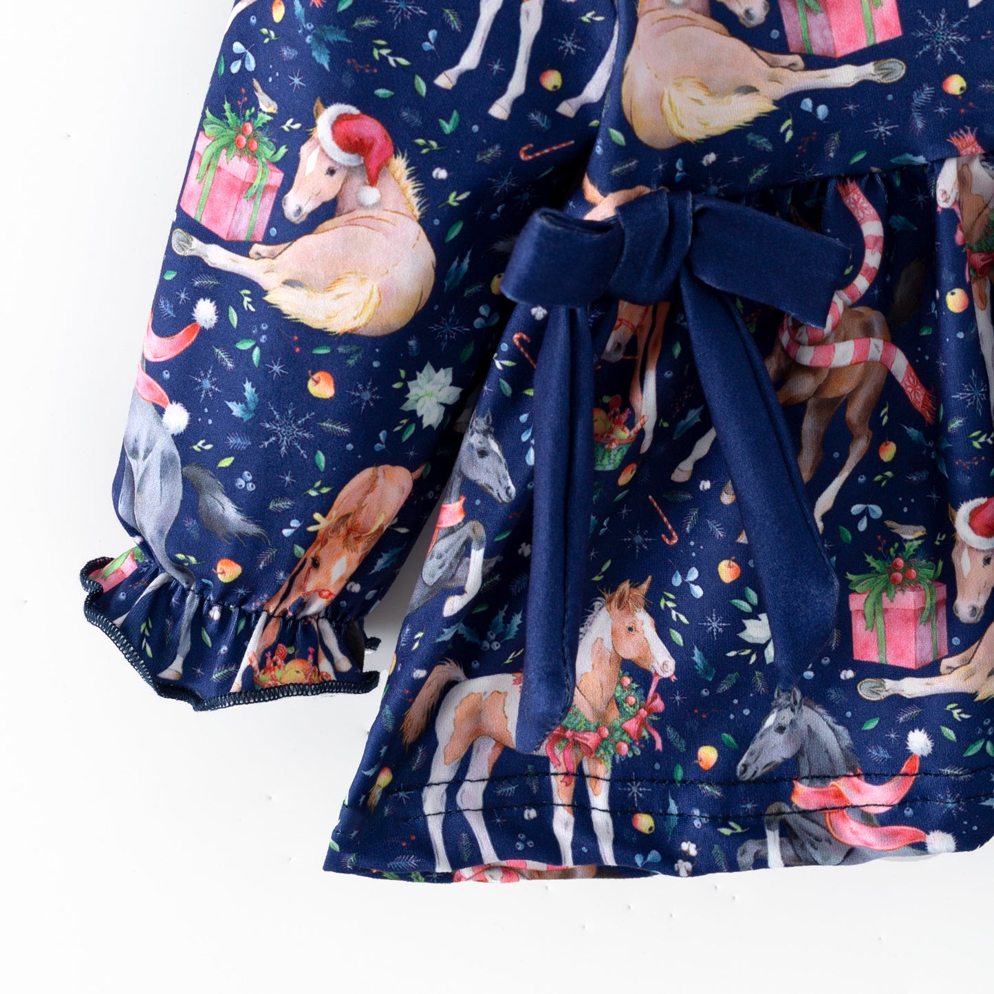 Navy blue children's outfit with printed Christmas horses on top and coordinating blue  bloomers. 