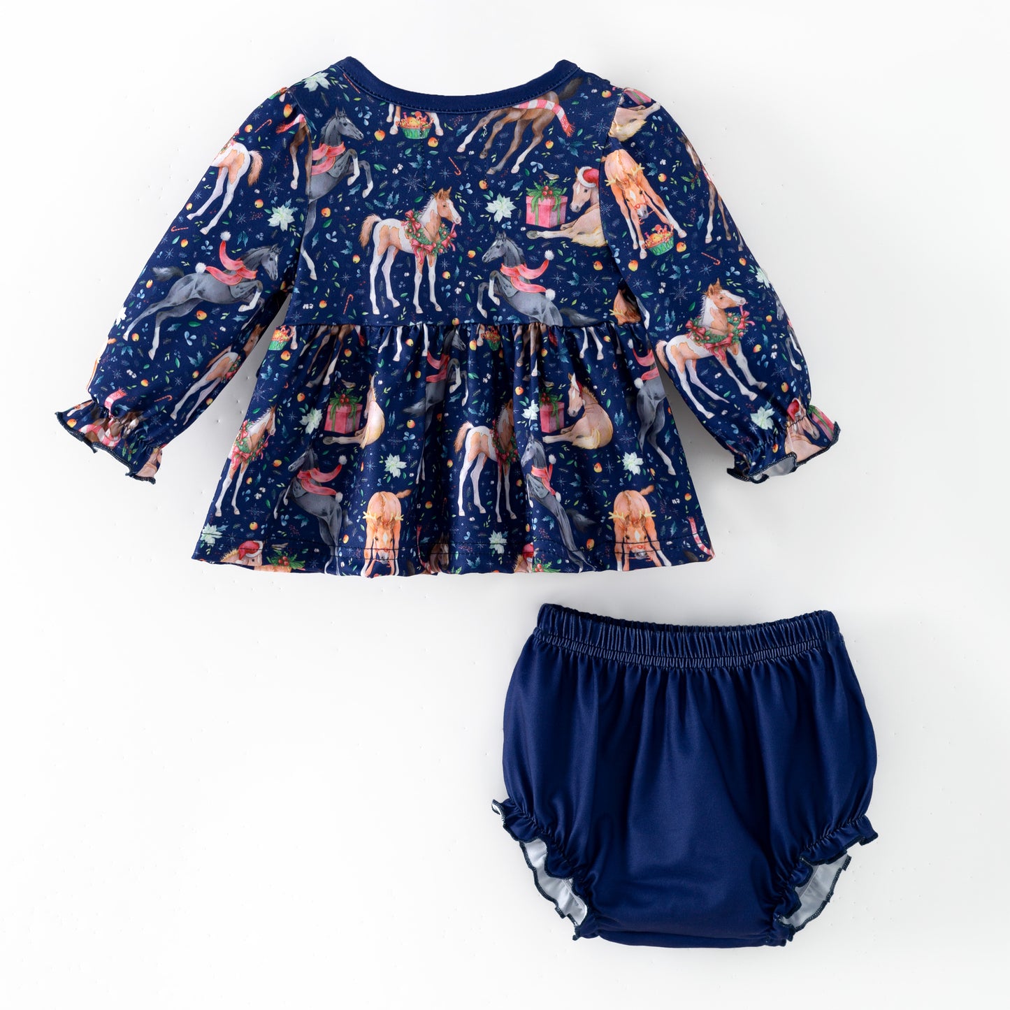 Navy blue children's outfit with printed Christmas horses on top and coordinating blue  bloomers. 