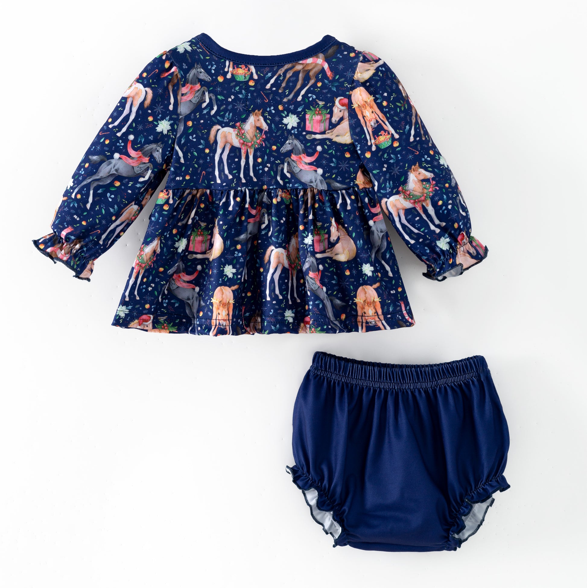 Navy blue children's outfit with printed Christmas horses on top and coordinating blue  bloomers. 