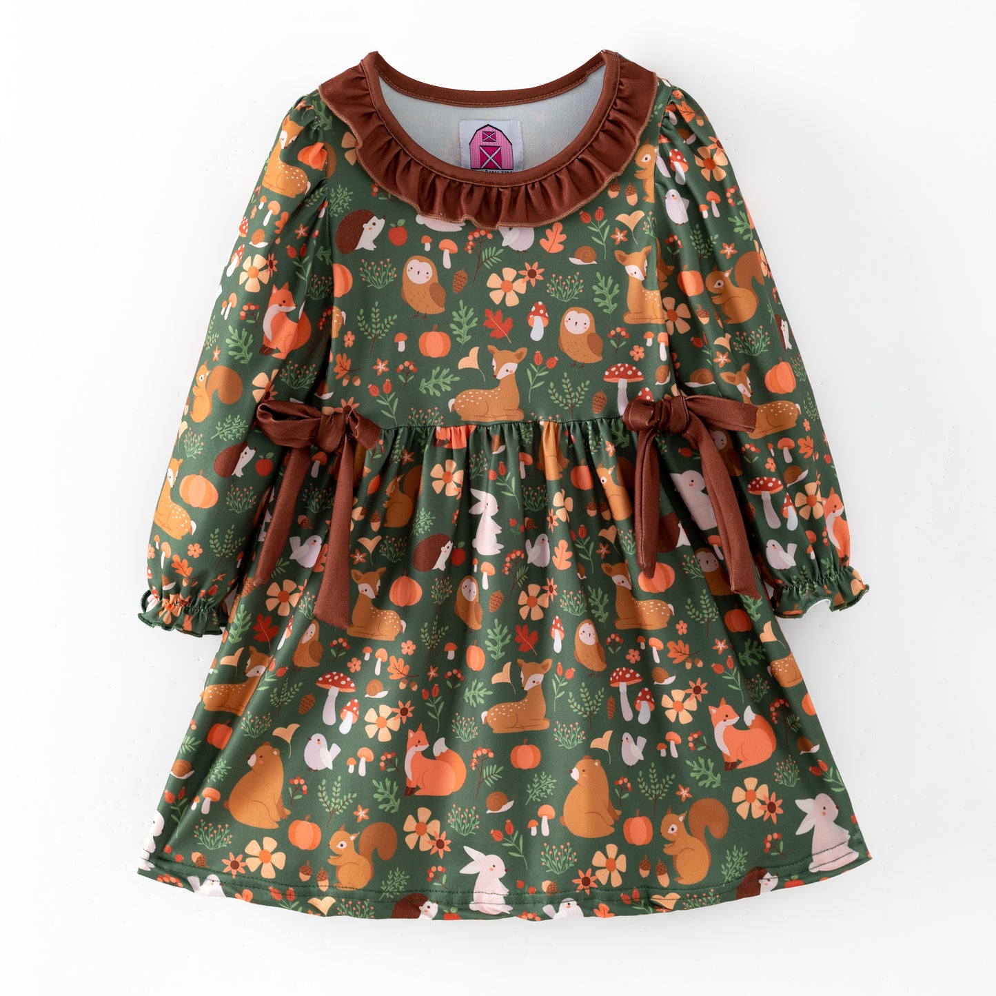 Children's dress with forest animal pattern on a dark green background