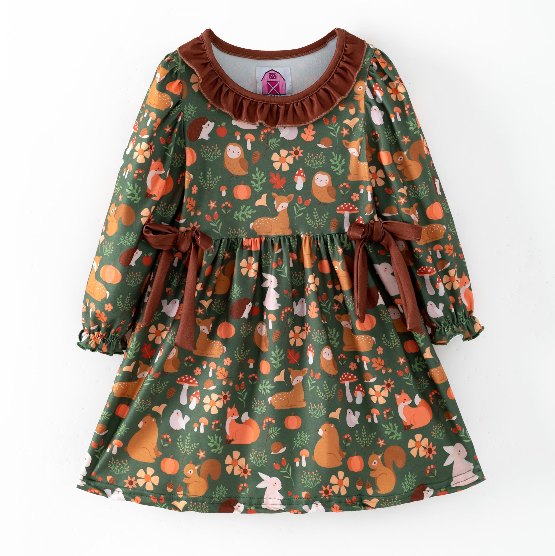 Children's dress with forest animal pattern on a dark green background
