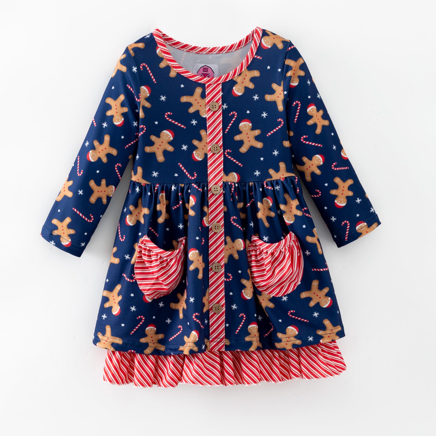 Children's dress with gingerbread man and candy cane pattern on a blue background
