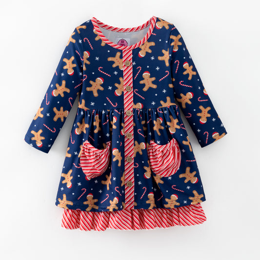 Children's dress with gingerbread man and candy cane pattern on a blue background