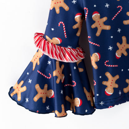 Sleeve of Navy blue top with gingerbread man pattern on a white background