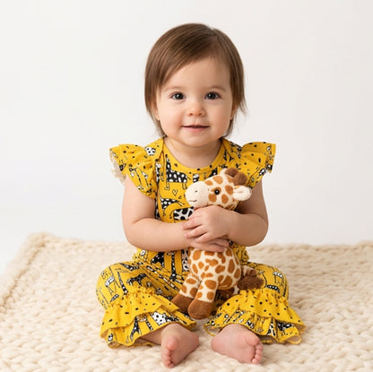 Baby wearing Giraffe Romper sitting on rug. White background