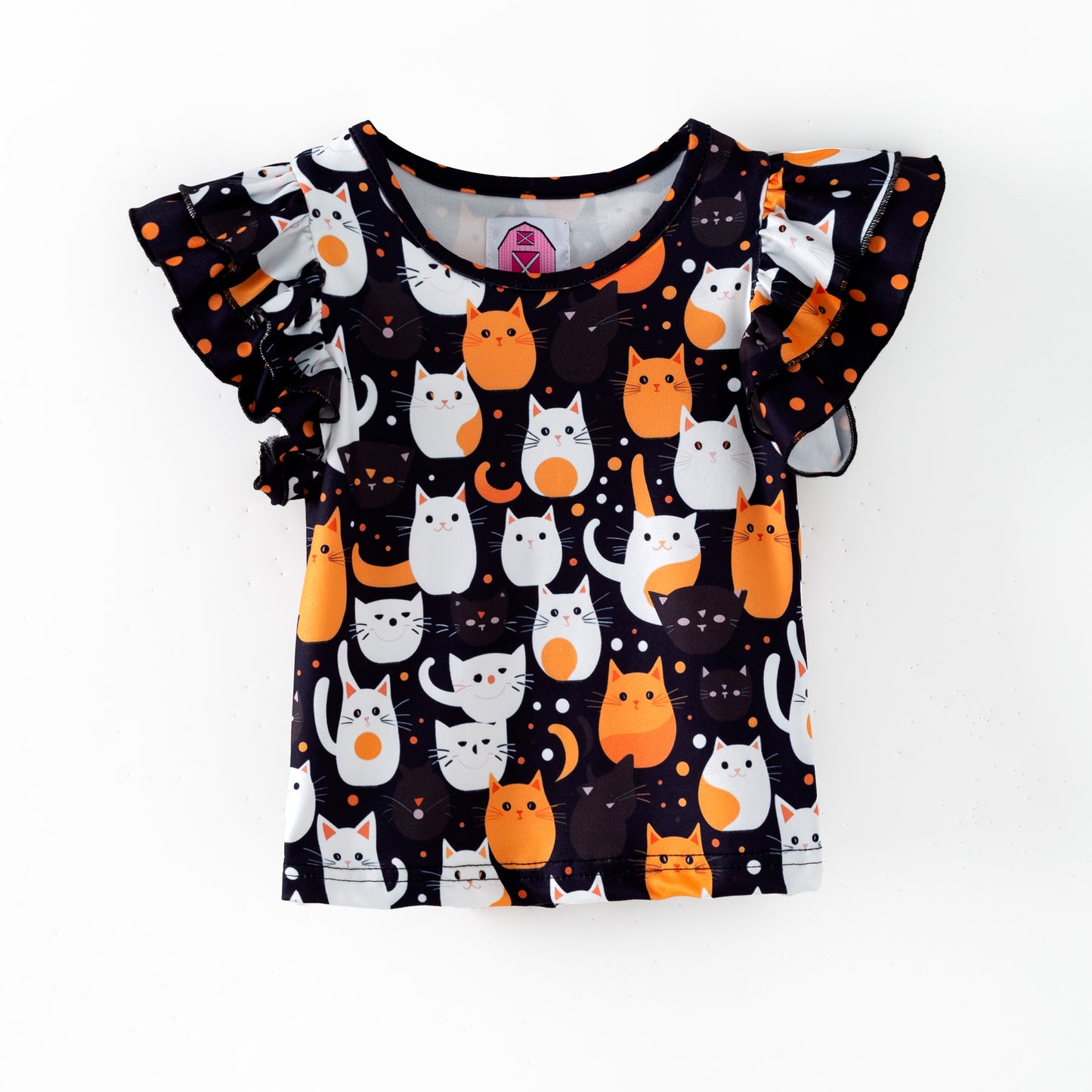 Double flutter sleeve top featuring white and orange Halloween cats on a black background