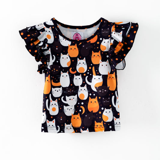 Double flutter sleeve top featuring white and orange Halloween cats on a black background