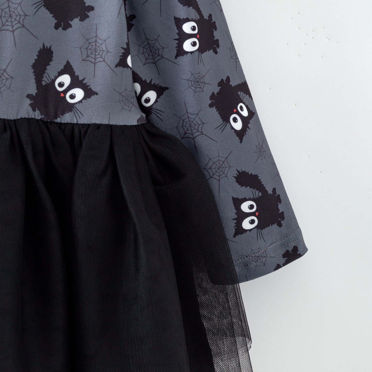 Sleeve of Black dress with cat pattern 