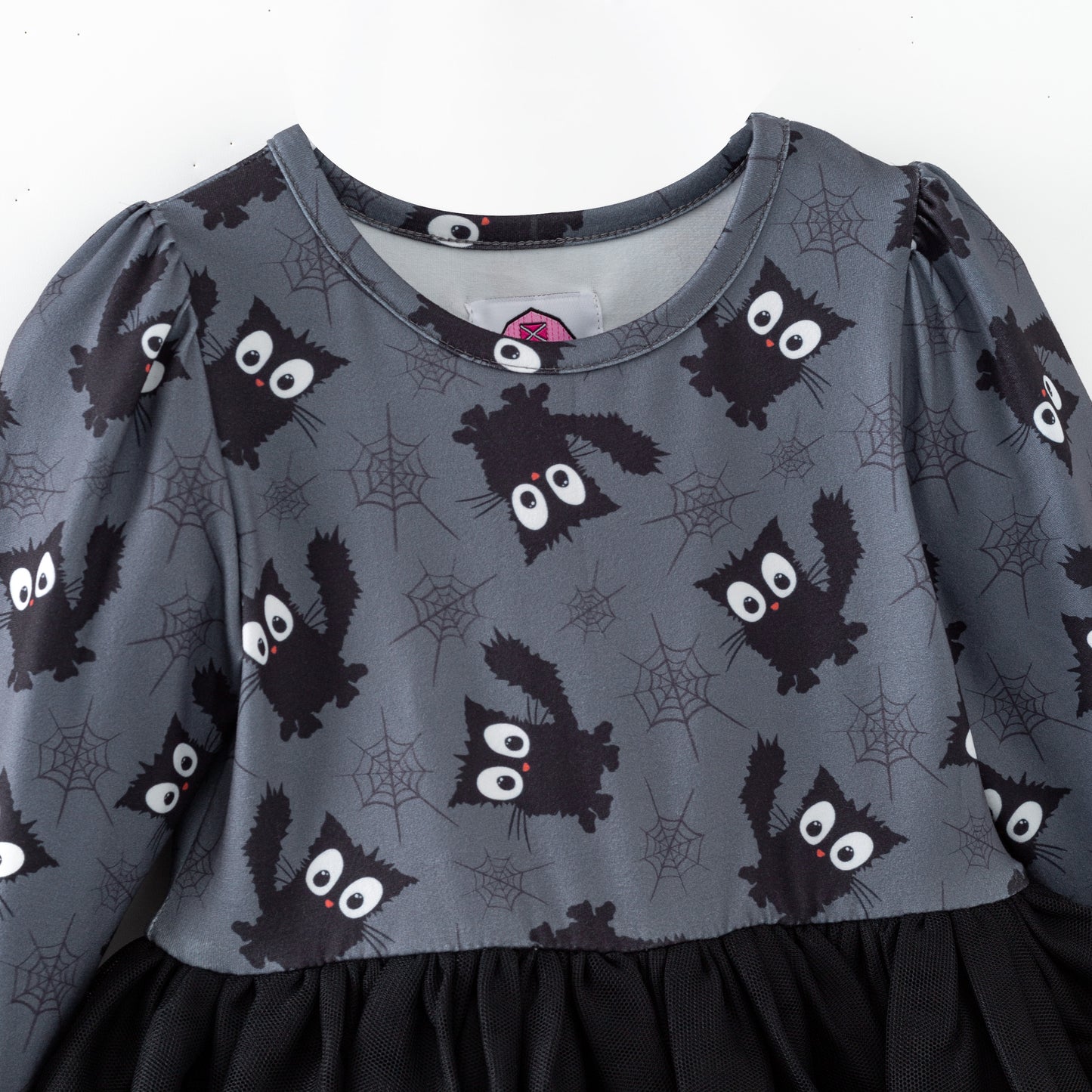 Children's dress with black cat pattern on a gray background