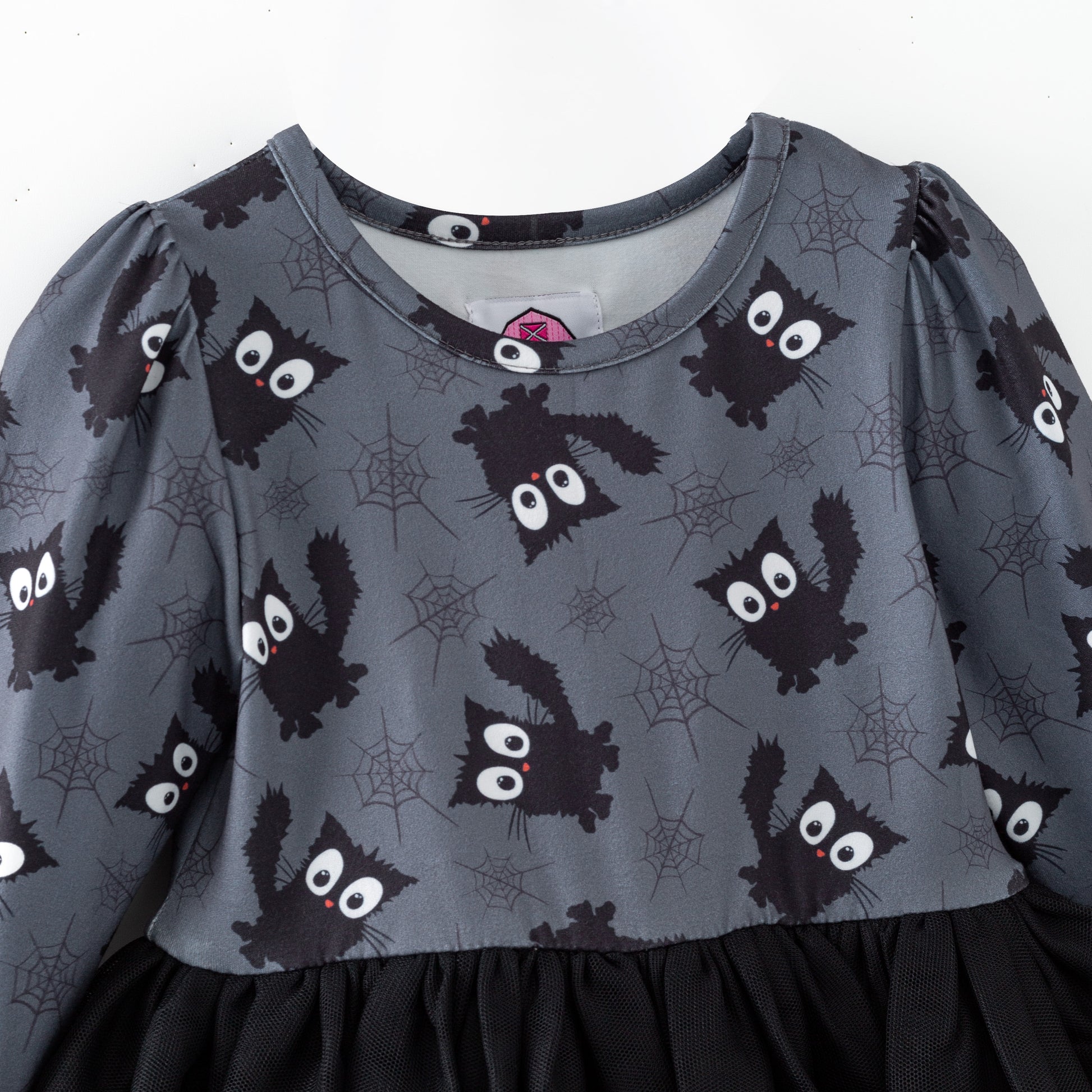 Children's dress with black cat pattern on a gray background