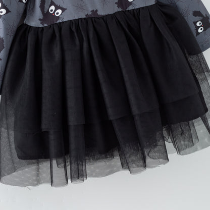Black tulle skirt with a patterned top on a white background