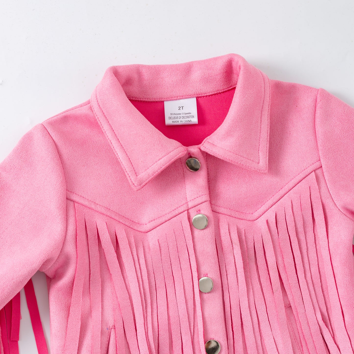 Close-up of a pink fringed jacket with buttons on a white background