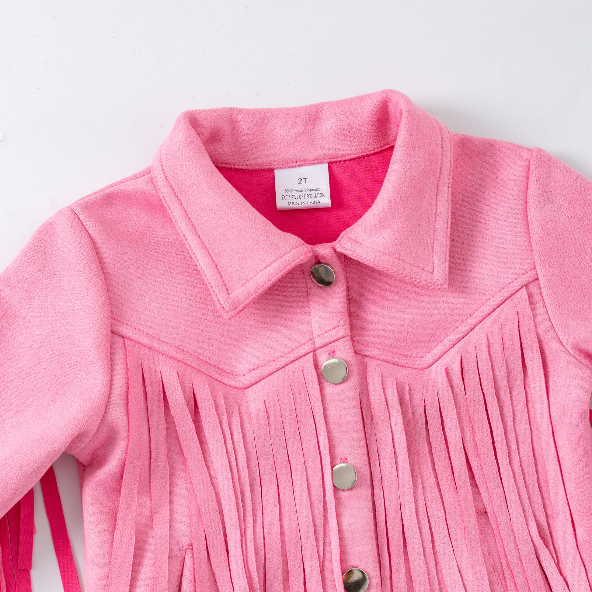 Close-up of a pink fringed jacket with buttons on a white background