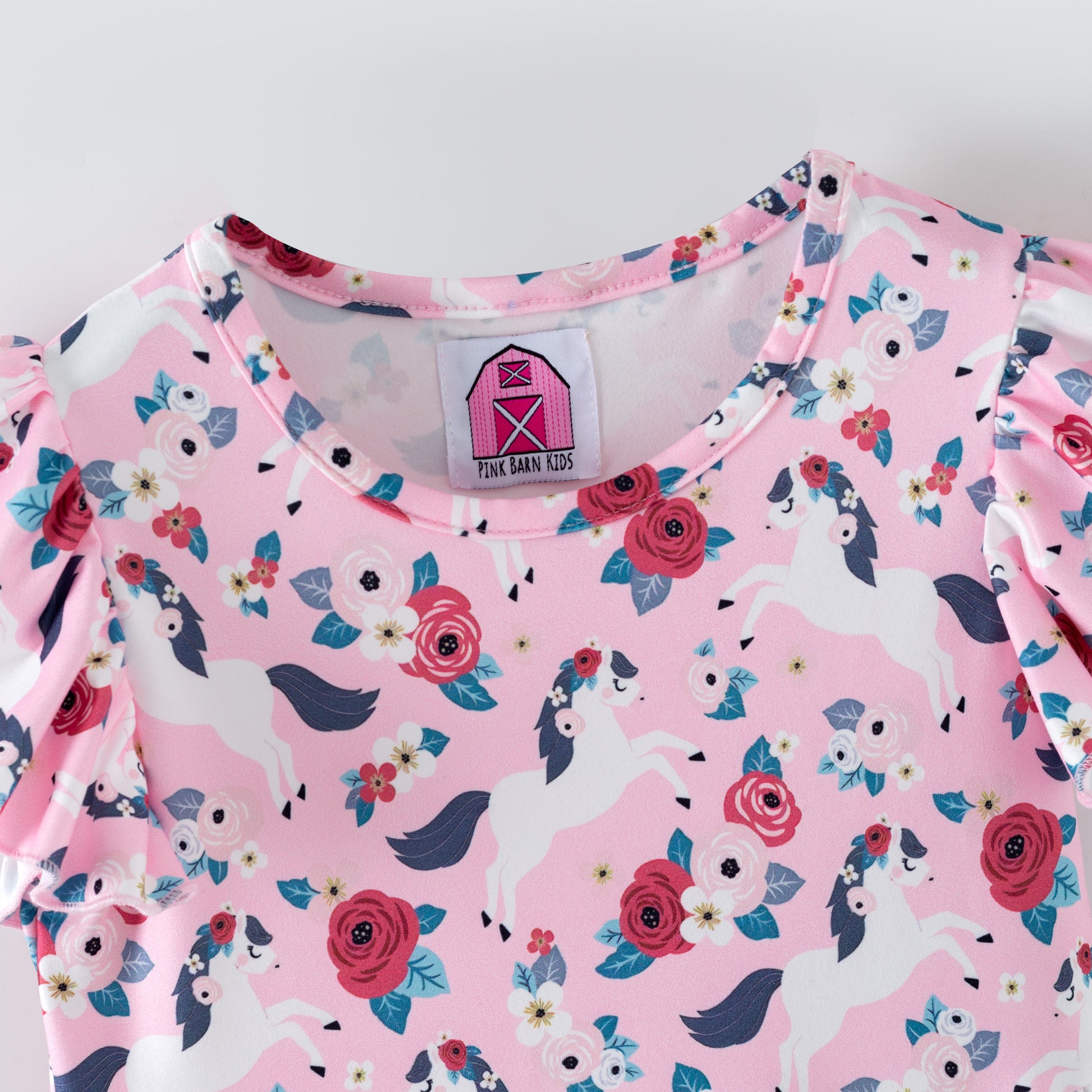 Pink floral dress with white horses on a pink background