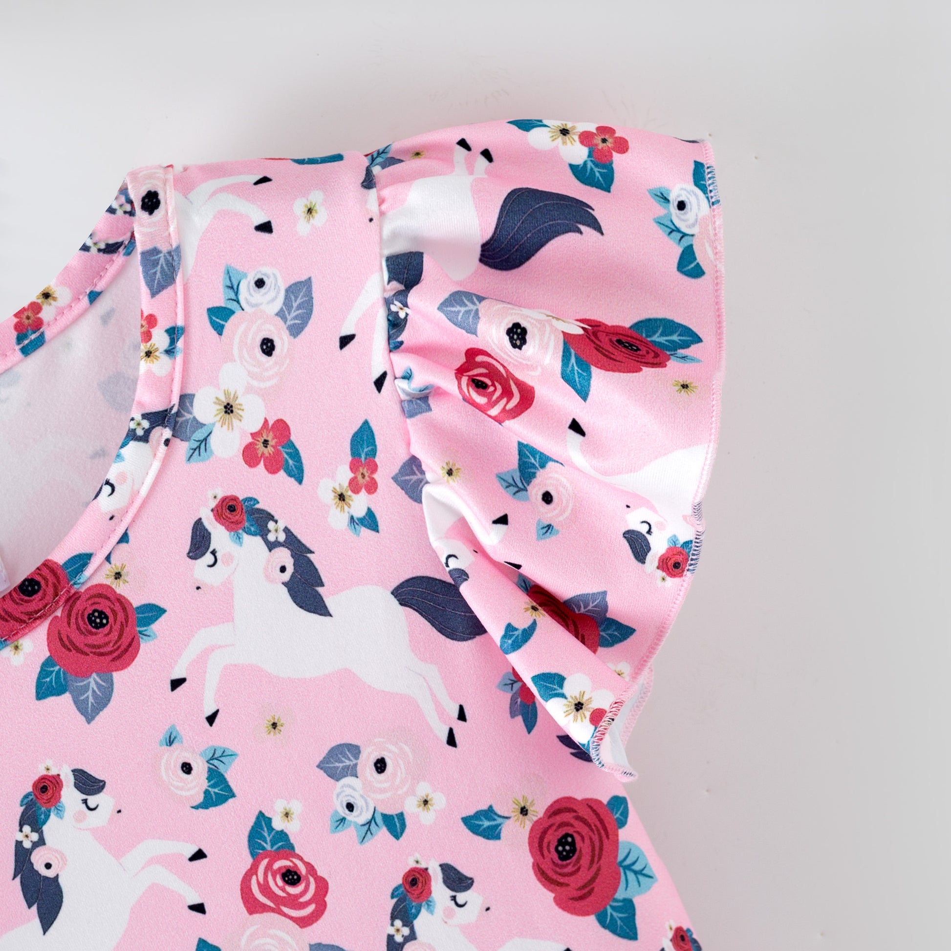 Pink floral dress with white horses on a pink background