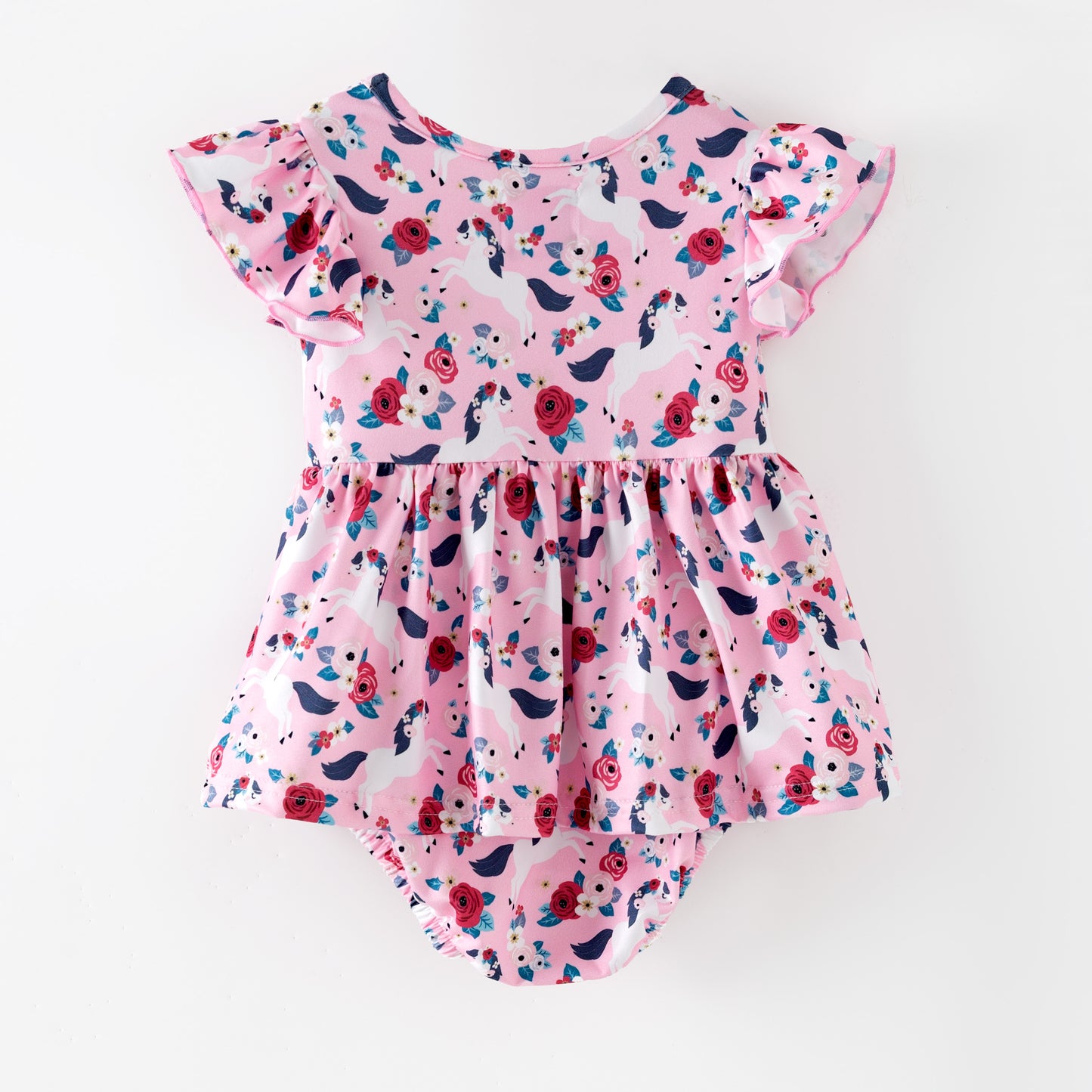 Pink floral baby romper with white horses on a pink background