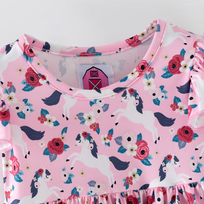 Pink floral baby romper with white horses on a pink background