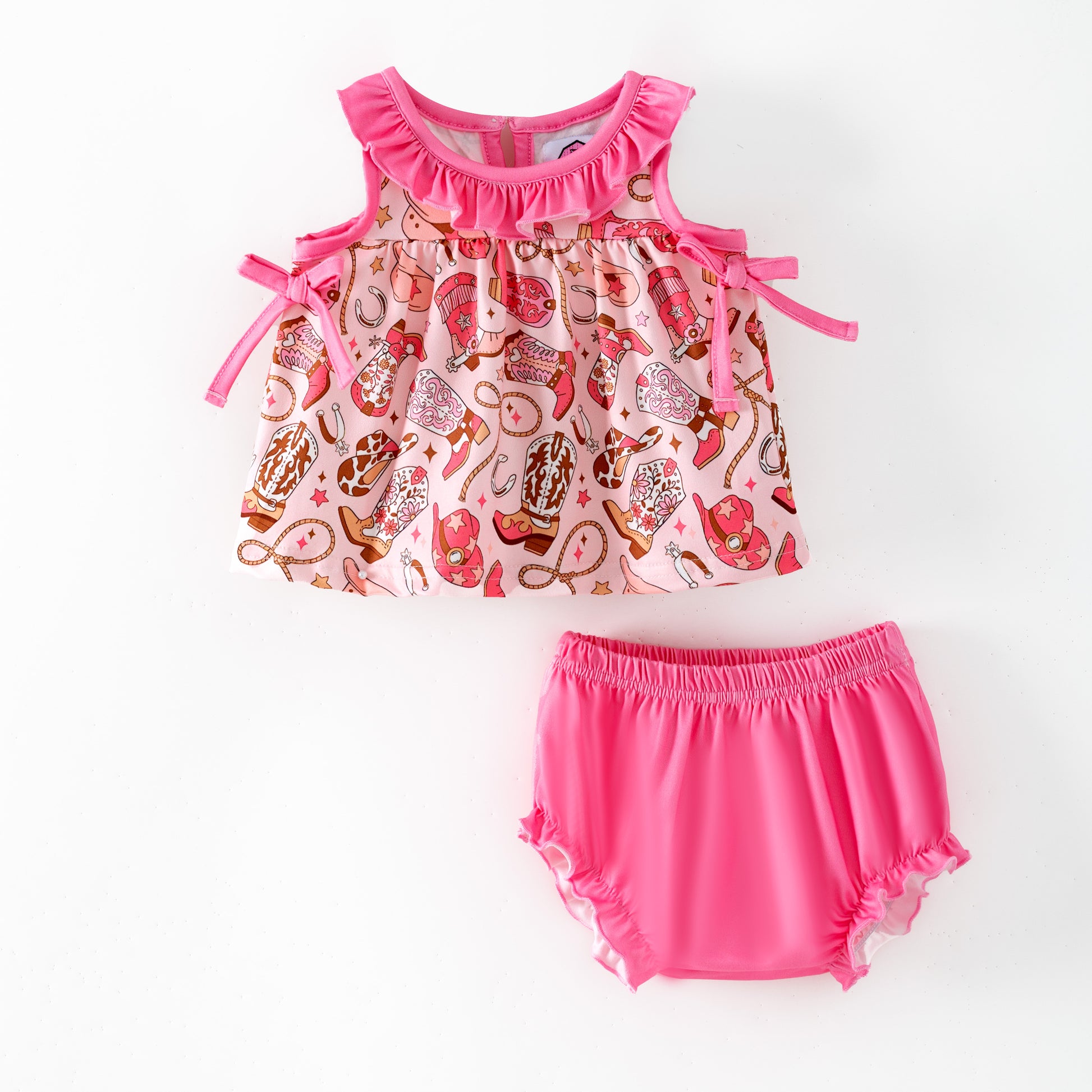 Children's outfit with a boot patterned top and pink bloomers 