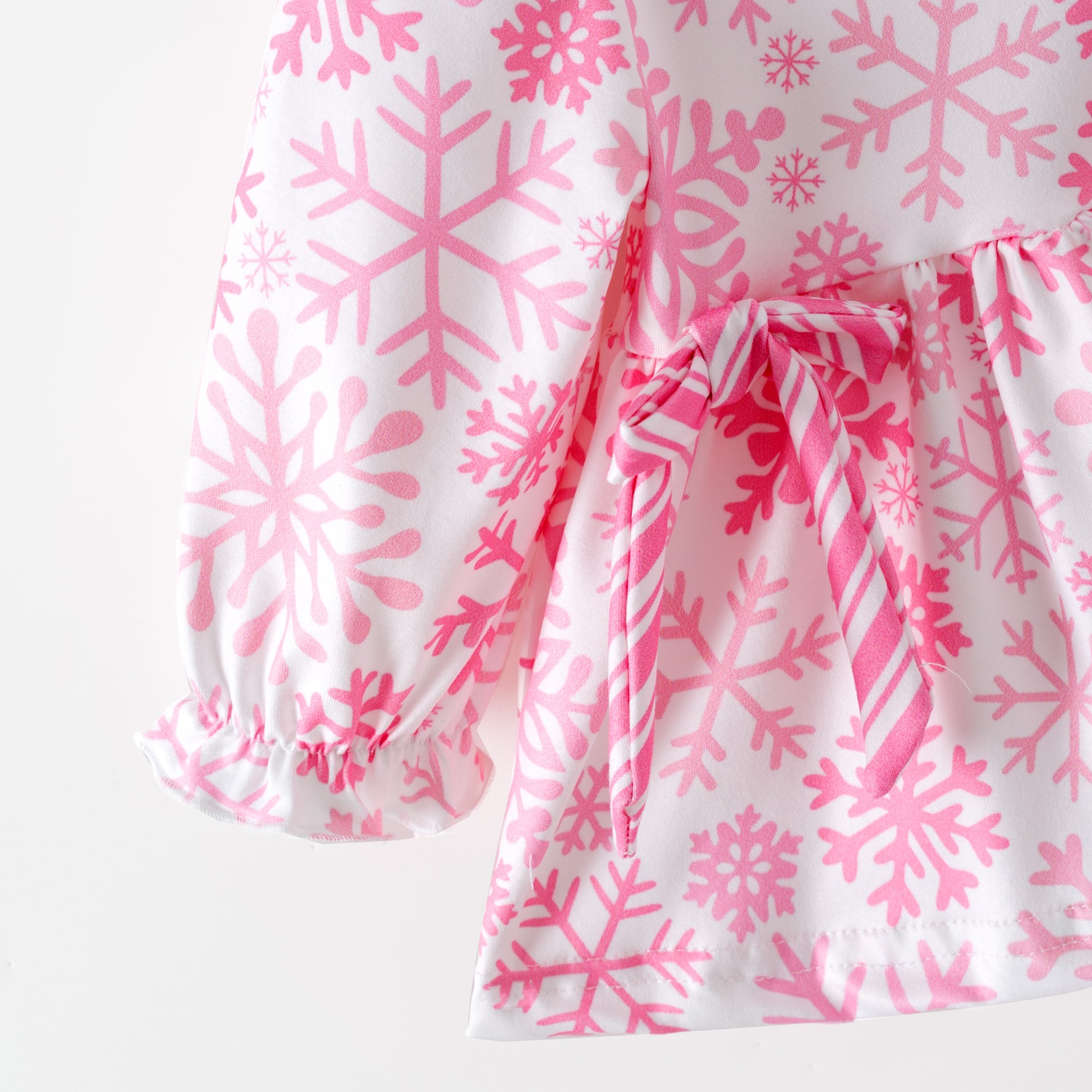 Children's pink and white snowflake dress with matching bloomers on a white background