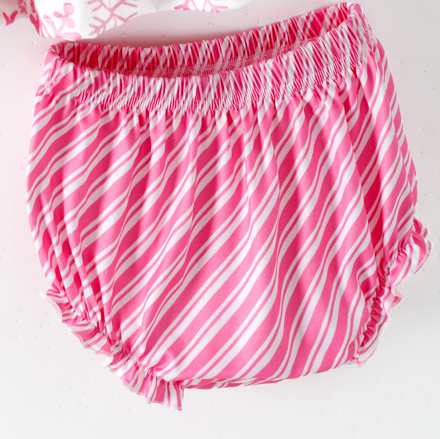 Pink and white striped diaper cover on a white background