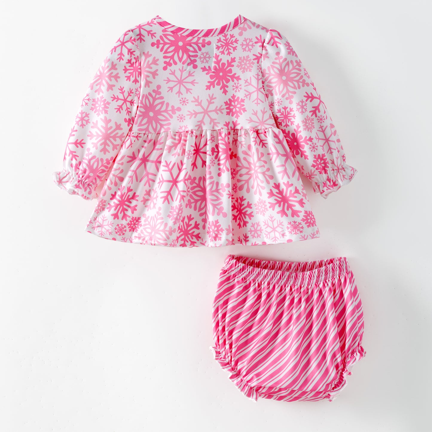 Children's pink and white snowflake dress with matching bloomers on a white background