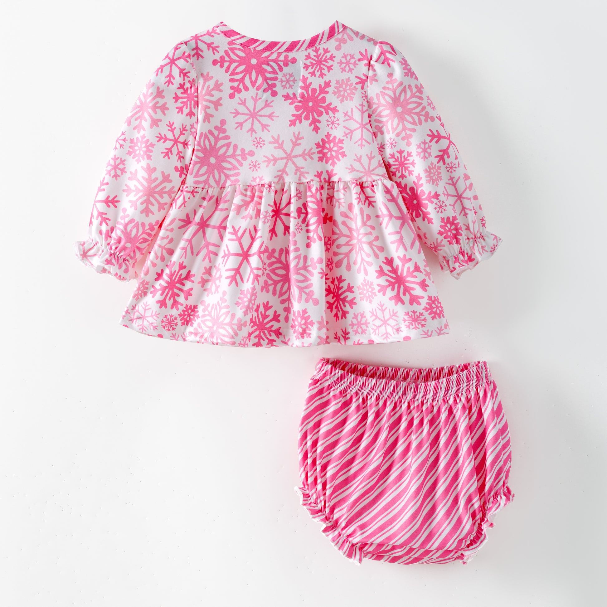 Children's pink and white snowflake dress with matching bloomers on a white background