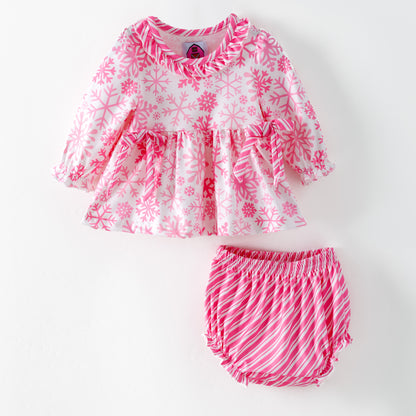 Children's pink and white snowflake dress with matching bloomers on a white background