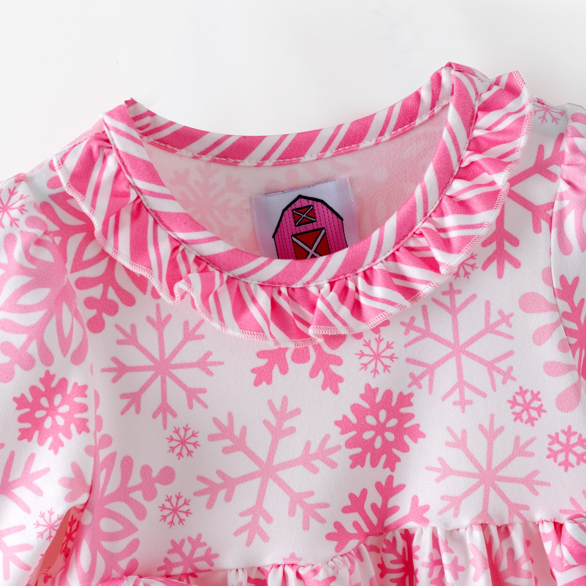 Children's pink and white snowflake dress with matching bloomers on a white background