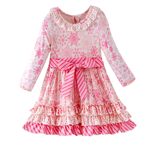 Pink and white snowflake dress with ruffled layers on a white background