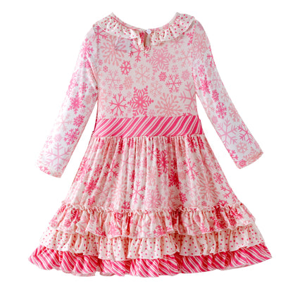 Pink and white snowflake dress with ruffled layers on a white background