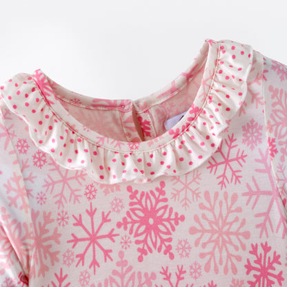 Pink and white snowflake dress with ruffled layers on a white background
