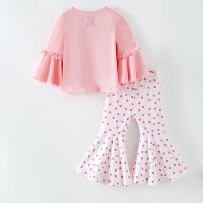Pink top and polka dot pants on a white background Back of outfit