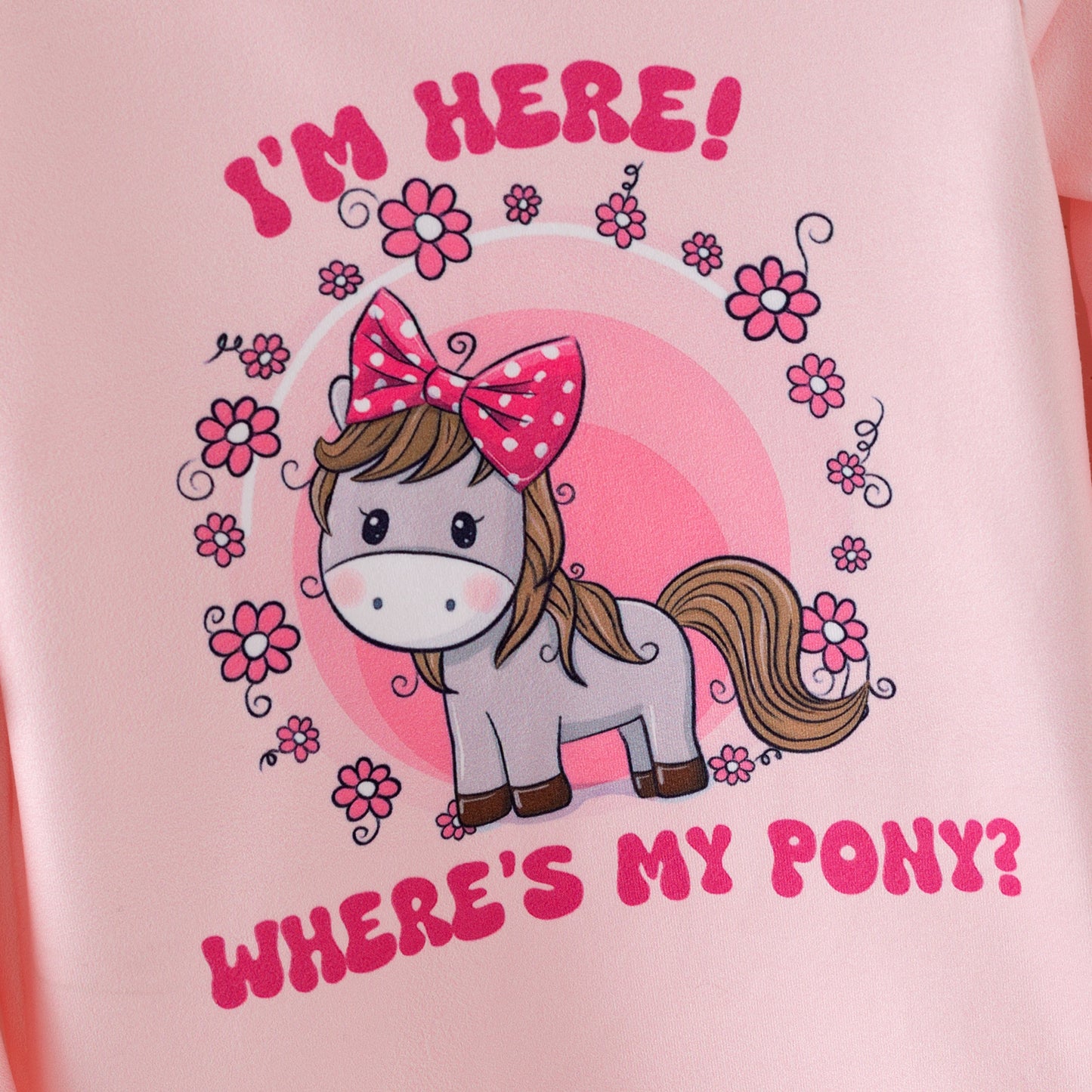 Pink shirt with a cartoon pony and text on a pink background